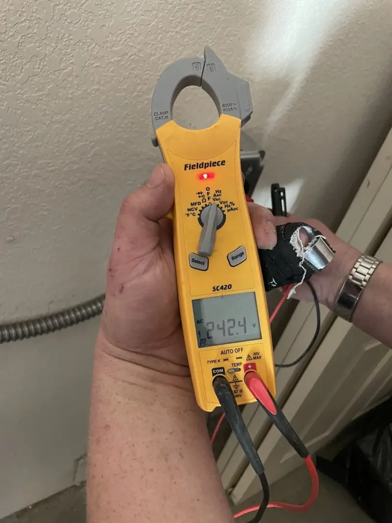 Voltage testing with clamp meter during Ceiling Fan Installation in Pacific
